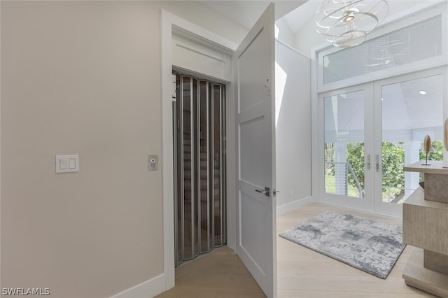 bathroom with french doors and hardwood / wood-style floors