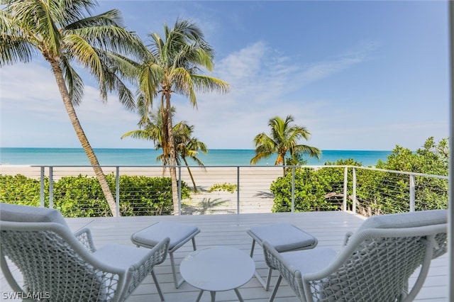 deck featuring a beach view and a water view