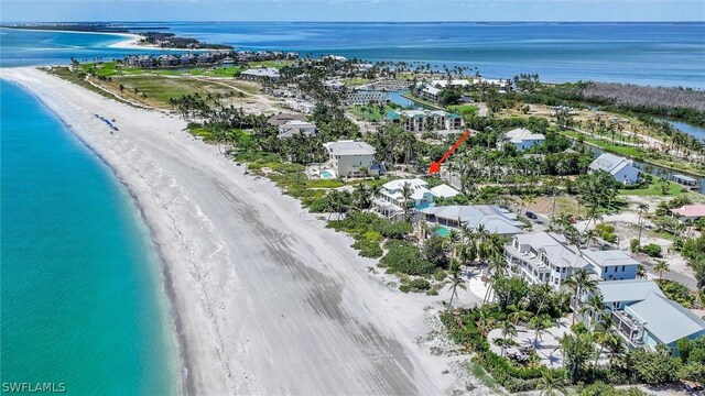 birds eye view of property with a beach view and a water view