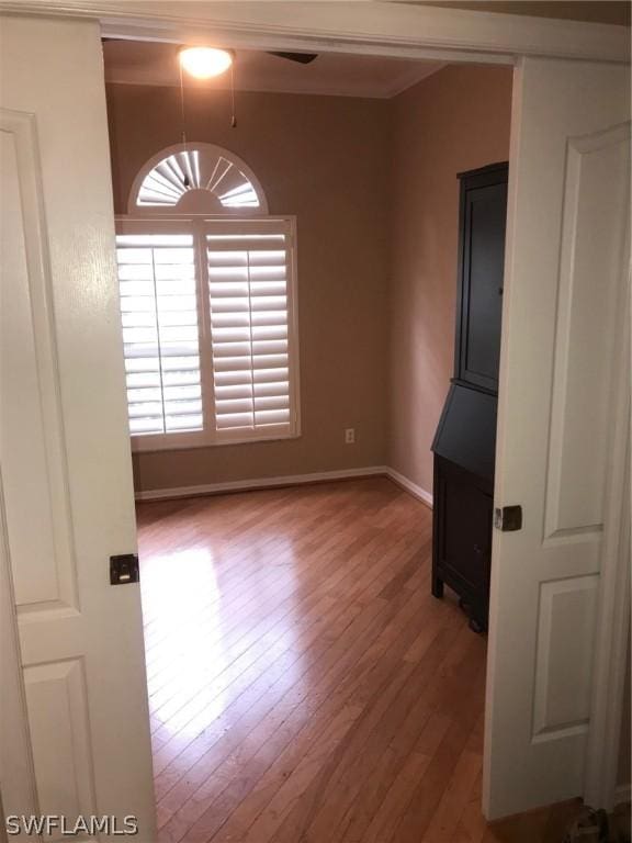 8853 Cypress Preserve Pl, Fort Myers, FL 33912 - empty room with wood finished floors, baseboards, a ceiling fan, and ornamental molding