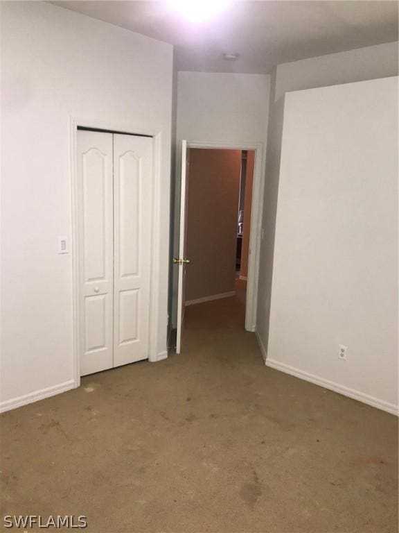 unfurnished bedroom featuring dark colored carpet