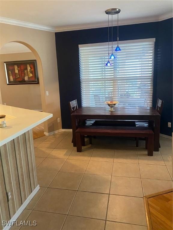 dining area featuring crown molding and tile patterned floors