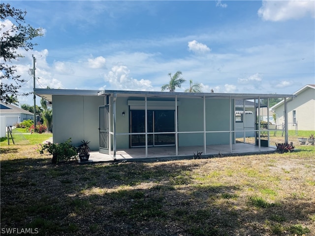 back of property featuring a patio area and a yard