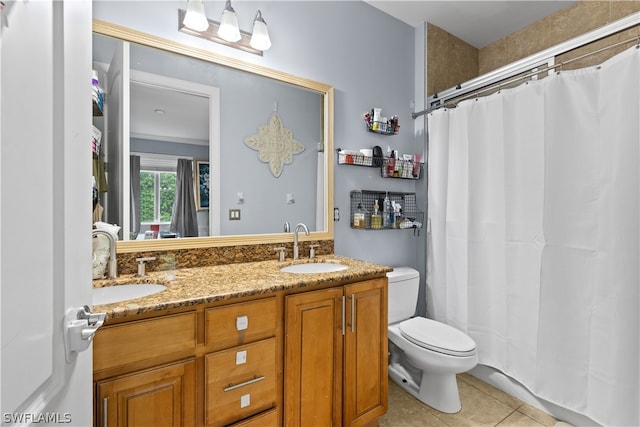 bathroom with dual vanity, tile flooring, toilet, and ornamental molding