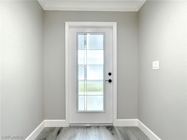 entryway featuring light wood-type flooring and crown molding