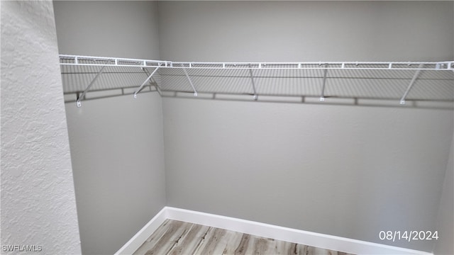 spacious closet featuring hardwood / wood-style floors