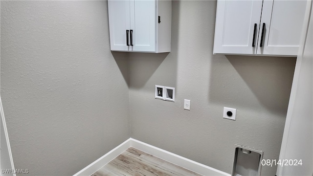 clothes washing area with washer hookup, light hardwood / wood-style flooring, cabinets, and hookup for an electric dryer