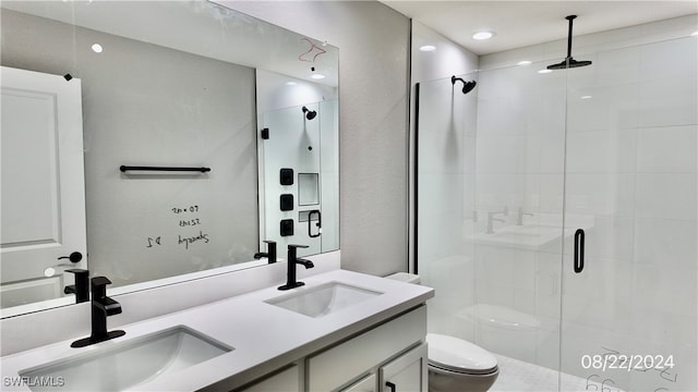 bathroom featuring vanity, toilet, and an enclosed shower