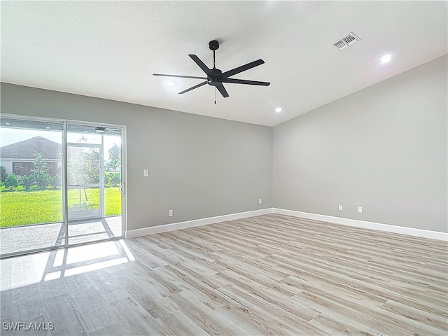 unfurnished room featuring a textured ceiling, ceiling fan, and light hardwood / wood-style floors