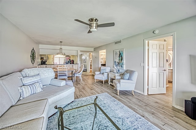 living room with ceiling fan and light hardwood / wood-style floors