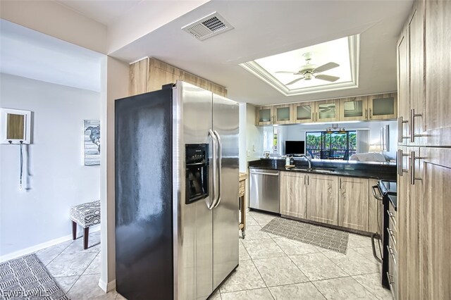 kitchen featuring ceiling fan, light tile patterned flooring, sink, and stainless steel appliances