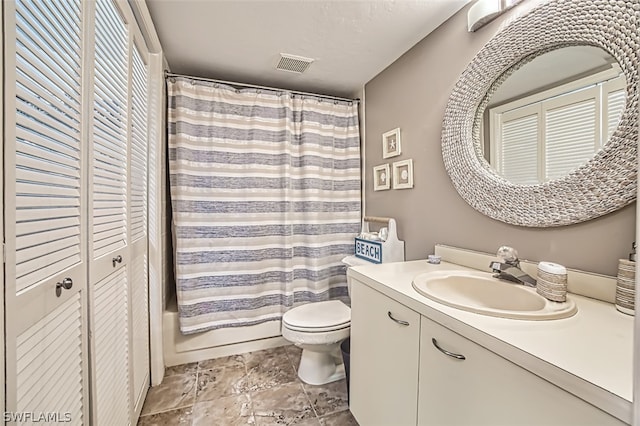 full bathroom with vanity, toilet, and shower / bath combo with shower curtain