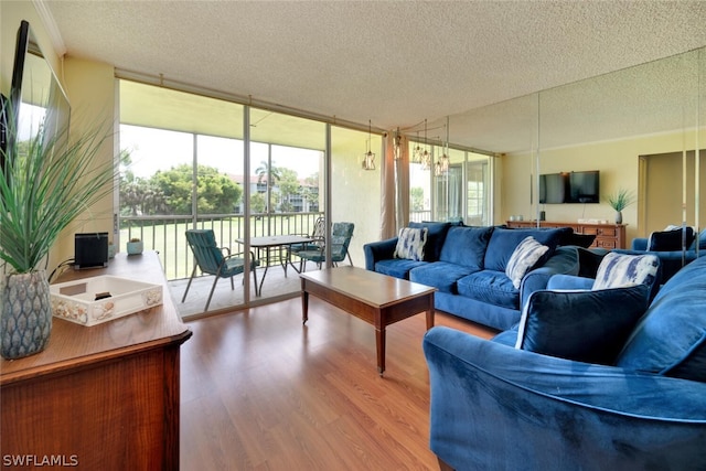 living room featuring a textured ceiling, hardwood / wood-style flooring, and floor to ceiling windows