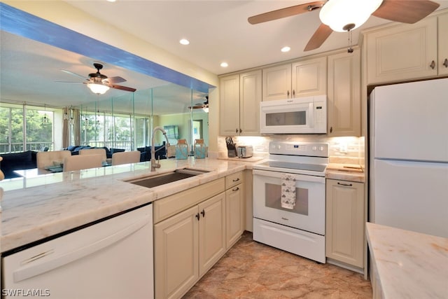 kitchen with sink, tasteful backsplash, light stone counters, kitchen peninsula, and white appliances