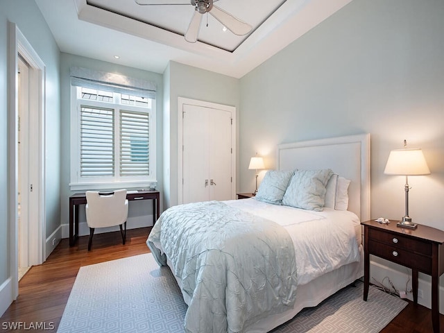 1270 Gulf Shore Blvd S, Naples, FL 34102 - bedroom featuring a raised ceiling, wood finished floors, a ceiling fan, and baseboards