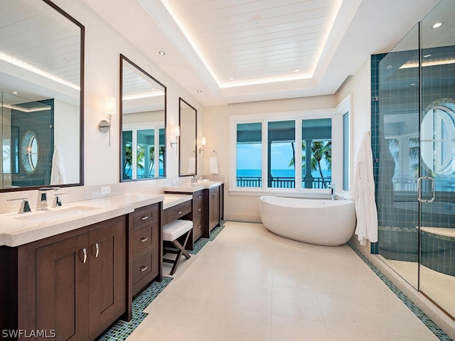 1270 Gulf Shore Blvd S, Naples, FL 34102 - bathroom with vanity, a freestanding bath, tile patterned floors, a stall shower, and a raised ceiling