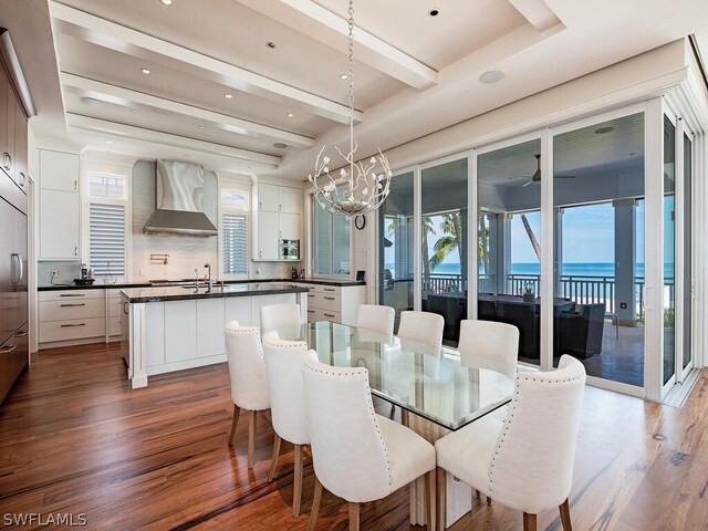 1270 Gulf Shore Blvd S, Naples, FL 34102 - dining room with dark wood-style flooring, a water view, a notable chandelier, and beam ceiling