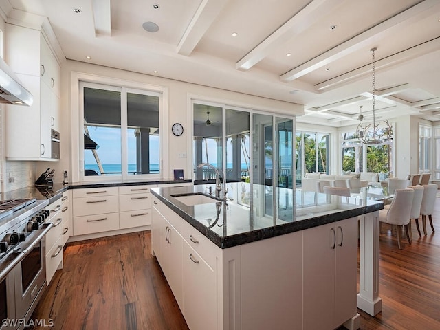 1270 Gulf Shore Blvd S, Naples, FL 34102 - kitchen with range with two ovens, beam ceiling, dark wood finished floors, a sink, and wall chimney exhaust hood
