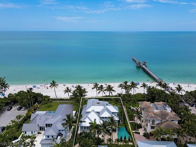 drone / aerial view with a beach view and a water view