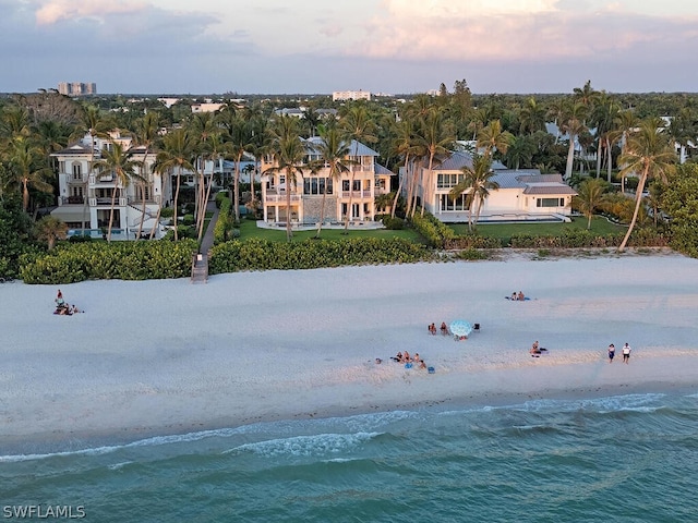 aerial view with a water view, a residential view, and a view of the beach