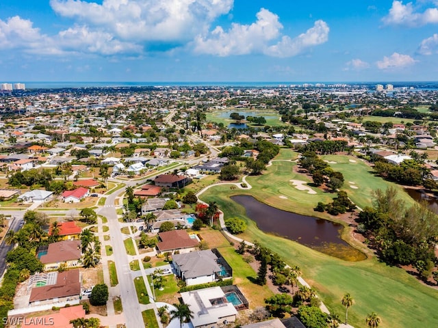 bird's eye view featuring a water view, view of golf course, and a residential view