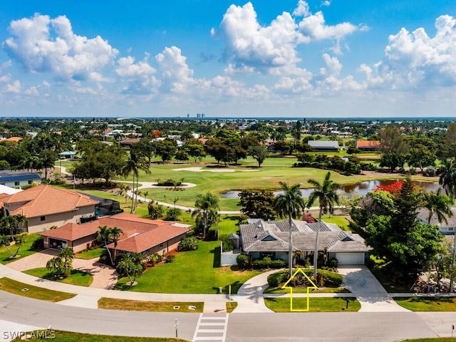 drone / aerial view featuring a water view, a residential view, and golf course view