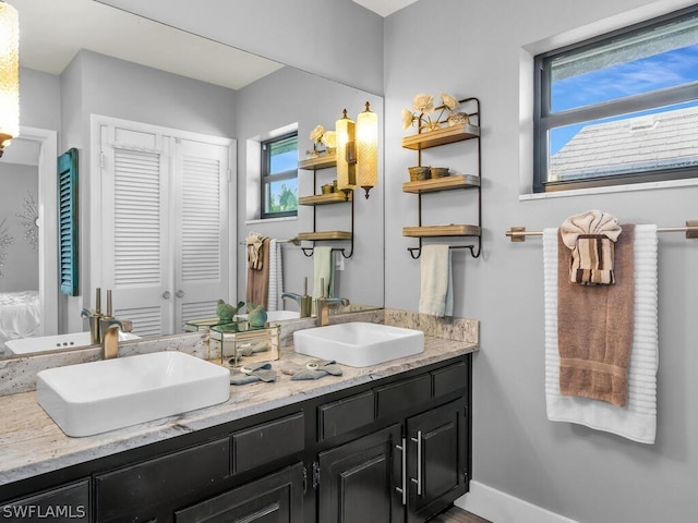 full bath with a sink and double vanity