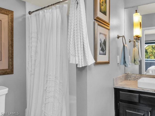 full bath featuring vanity, shower / bath combination with curtain, and toilet