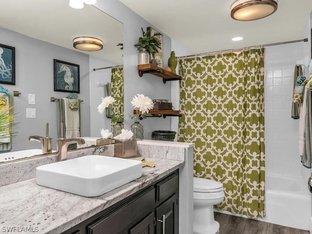 full bath with vanity, shower / bathtub combination with curtain, toilet, and wood finished floors
