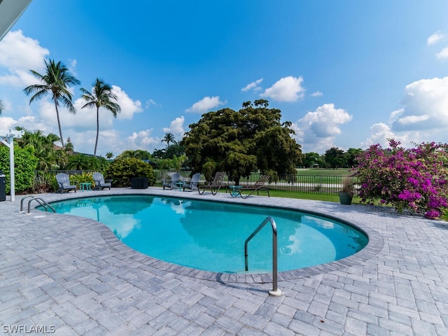view of pool with a fenced in pool, fence, and a patio area