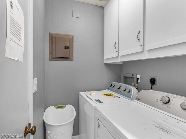 laundry room with cabinet space, independent washer and dryer, and electric panel
