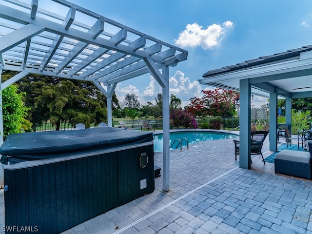 view of pool with a fenced backyard, a hot tub, and a patio area