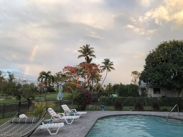 view of pool at dusk