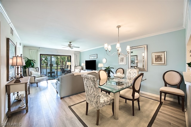 dining space with crown molding, ceiling fan with notable chandelier, and light wood-type flooring