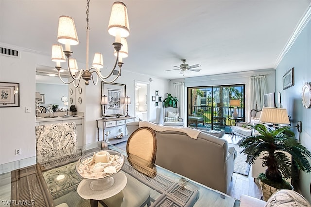 dining space featuring ornamental molding, sink, ceiling fan with notable chandelier, and wood-type flooring