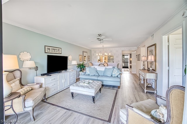 living room featuring ornamental molding, ceiling fan with notable chandelier, and light hardwood / wood-style floors