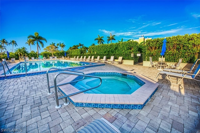 view of pool featuring a community hot tub and a patio