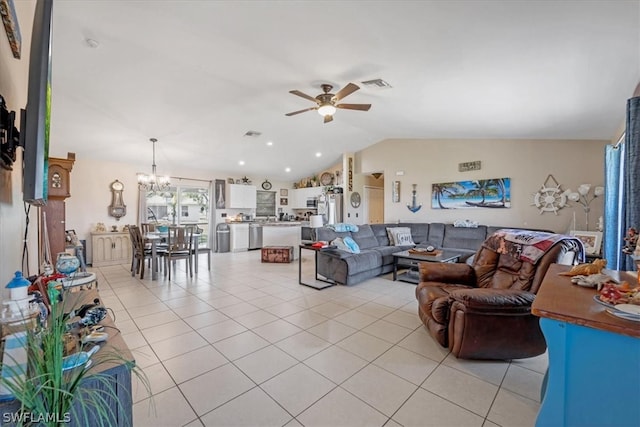 living room with ceiling fan with notable chandelier, vaulted ceiling, and light tile patterned flooring