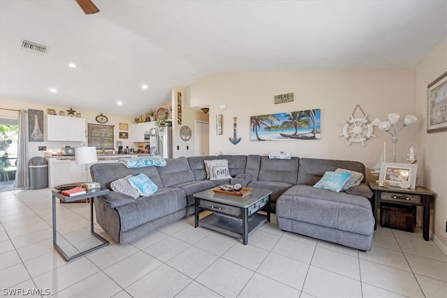 living room featuring light tile patterned floors, ceiling fan, and lofted ceiling