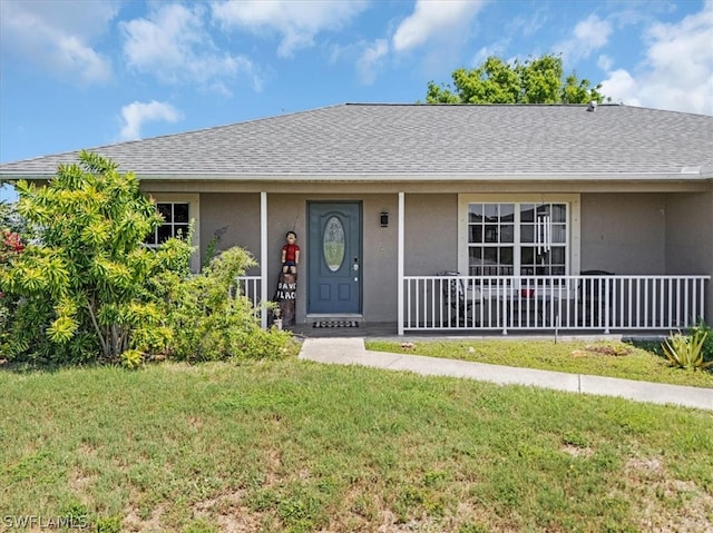 single story home with covered porch and a front yard