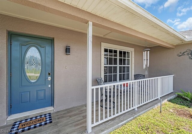 view of exterior entry featuring a porch