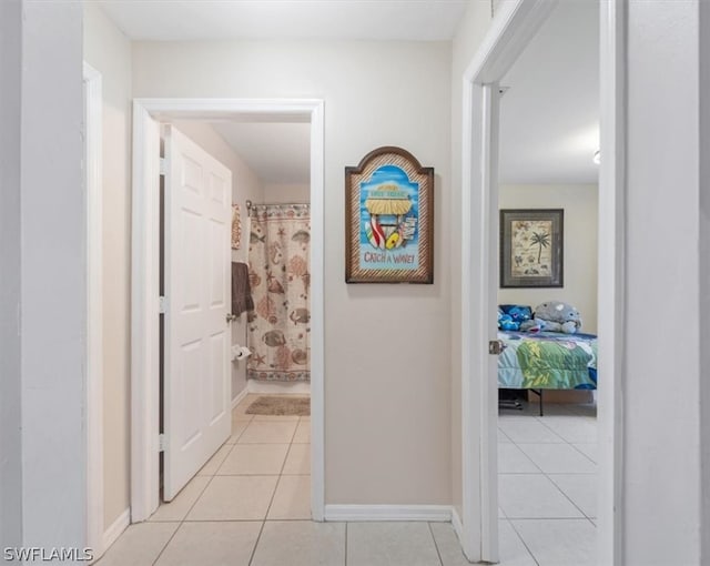 hall featuring light tile patterned floors