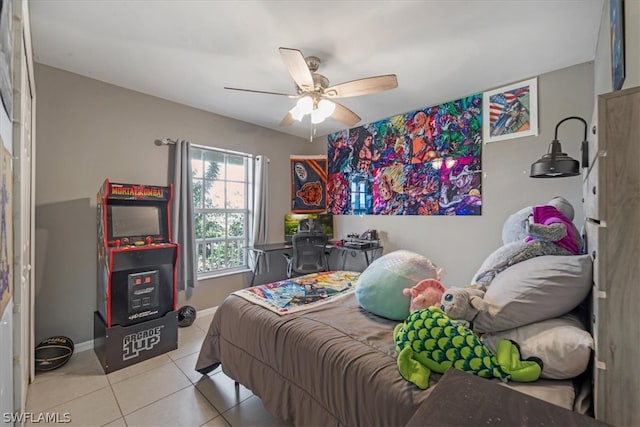 tiled bedroom featuring ceiling fan