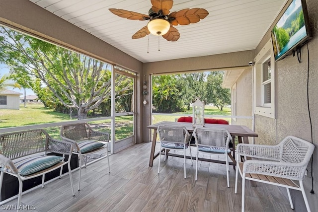 sunroom / solarium with ceiling fan and wood ceiling