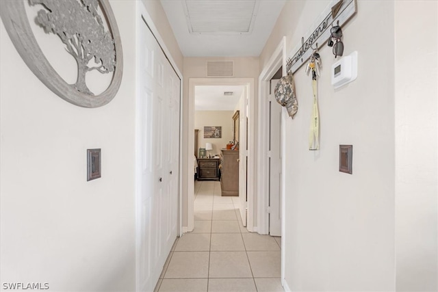 hall featuring light tile patterned flooring