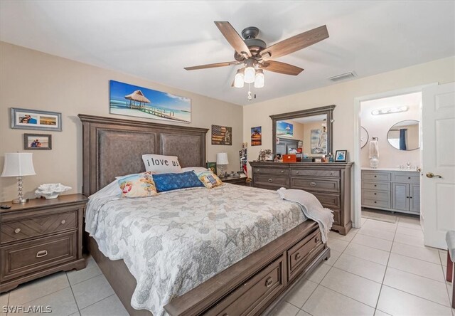 tiled bedroom with ensuite bathroom and ceiling fan