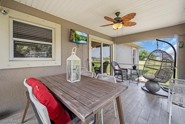 sunroom with wood ceiling and ceiling fan