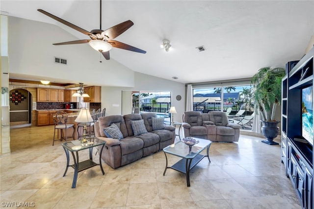 living room featuring ceiling fan and vaulted ceiling