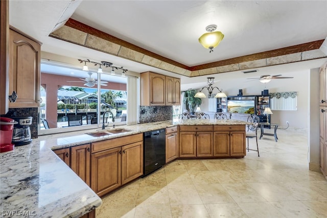 kitchen featuring sink, decorative backsplash, black dishwasher, light stone counters, and kitchen peninsula