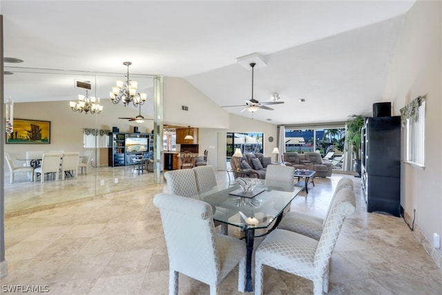 dining room with ceiling fan with notable chandelier and lofted ceiling